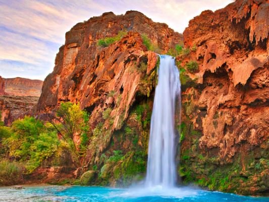 A breathtaking waterfall tumbles down in Arizona, showcasing the region's natural beauty and rugged terrain