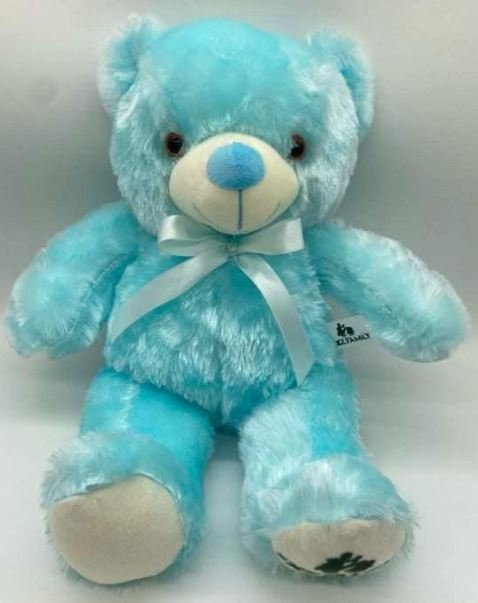A blue teddy bear adorned with a white bow, sitting upright and exuding a charming, playful demeanor.