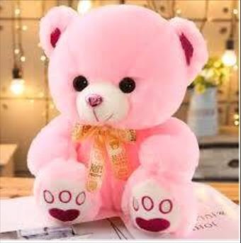 A pink teddy bear adorned with a charming bow, exuding warmth and cuteness in its soft, plush design.